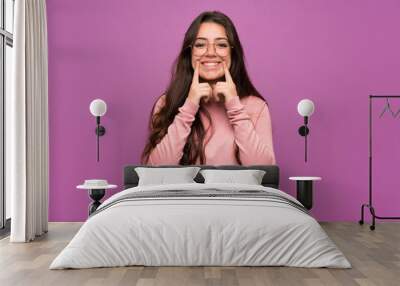 Teenager girl over purple wall smiling with a happy and pleasant expression Wall mural