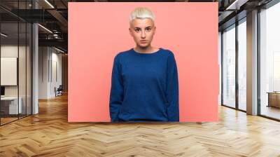 Teenager girl with white short hair over pink wall with sad and depressed expression Wall mural