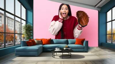 Teenager player with baseball glove isolated on pink background with surprise and shocked facial expression Wall mural