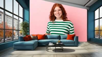 Teenager redhead girl over isolated pink background laughing Wall mural