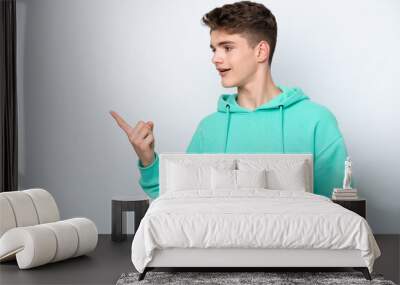 Teenager Russian man isolated on white background intending to realizes the solution while lifting a finger up Wall mural