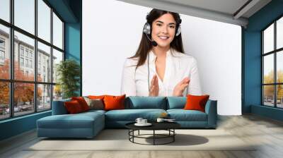 Telemarketer caucasian woman working with a headset isolated on white background applauding after presentation in a conference Wall mural