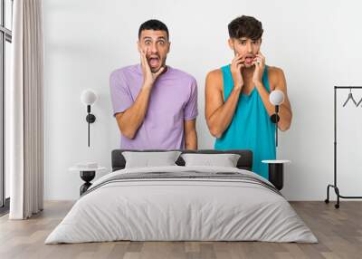 Two men over isolated background surprised and shocked while looking right Wall mural