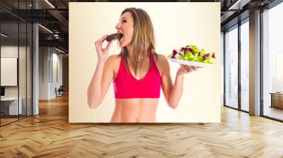 woman undecided between a donut and a salad Wall mural