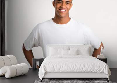 Young african american man posing with arms at hip and laughing looking to the front on isolated background Wall mural