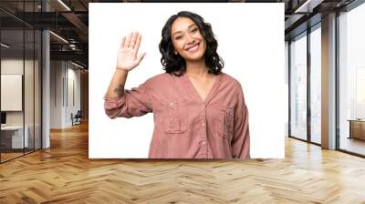 Young Argentinian woman over isolated background saluting with hand with happy expression Wall mural