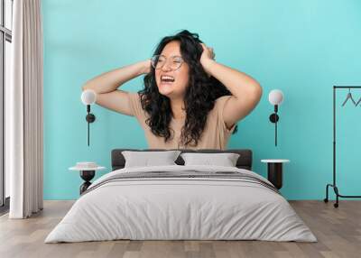 Young asian woman isolated on blue background stressed overwhelmed Wall mural