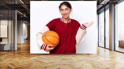 Young basketball player woman isolated on white background with shocked facial expression Wall mural