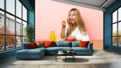 Young blonde woman having breakfast milk Wall mural