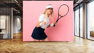 Young blonde woman isolated on pink background playing tennis Wall mural