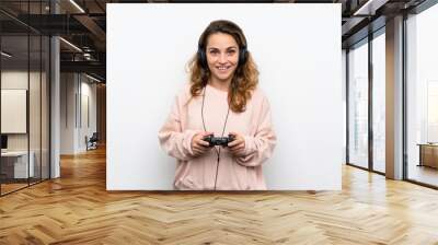 Young blonde woman playing at videogames Wall mural