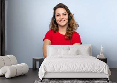 Young blonde woman working with headset Wall mural