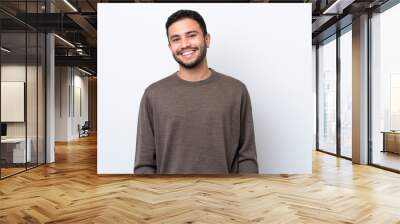 Young Brazilian man isolated on white background laughing Wall mural