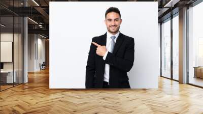 Young business man over isolated background pointing finger to the side Wall mural