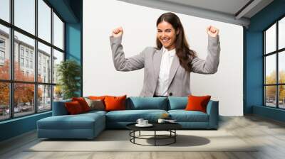 Young business woman over isolated white background celebrating a victory Wall mural