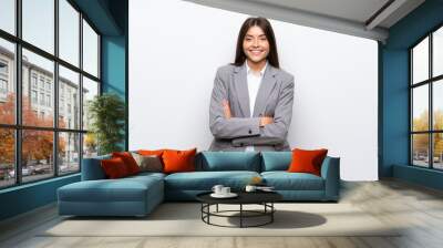 young business woman over isolated white background keeping the arms crossed in frontal position Wall mural