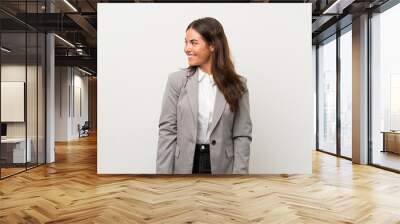 Young business woman over isolated white background looking to the side Wall mural