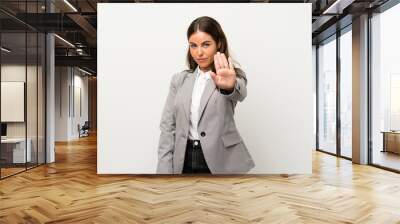 Young business woman over isolated white background making stop gesture with her hand Wall mural