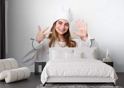 Young caucasian chef woman isolated on white background counting eight with fingers Wall mural