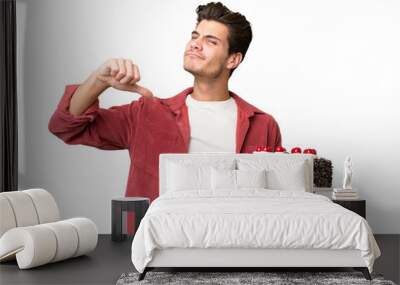 Young caucasian man holding birthday cake over isolated background proud and self-satisfied Wall mural