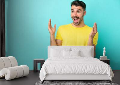 Young caucasian man isolated on blue background with surprise facial expression Wall mural