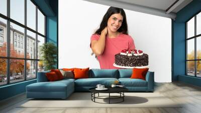 Young caucasian woman holding birthday cake isolated on white background laughing Wall mural