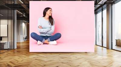 Young caucasian woman isolated on pink background happy and smiling Wall mural