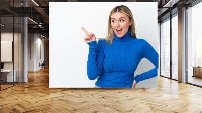 Young caucasian woman isolated on white background intending to realizes the solution while lifting a finger up Wall mural