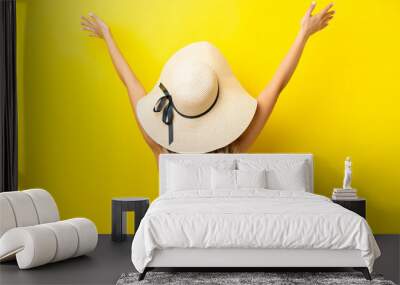 Young caucasian woman isolated on yellow background in swimsuit and in back position Wall mural