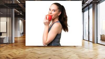 Young caucasian woman over isolated background eating an apple Wall mural