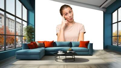 Young caucasian woman over isolated background thinking an idea Wall mural