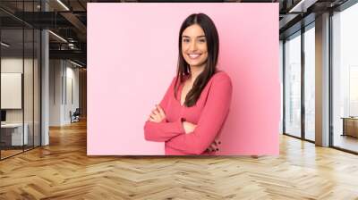 Young caucasian woman over isolated background with arms crossed and looking forward Wall mural