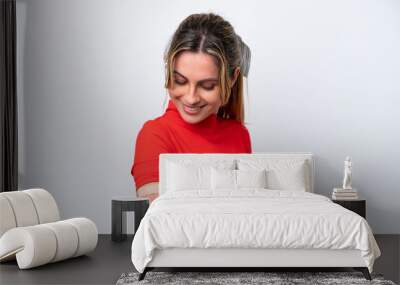 Young caucasian woman wearing band-aids isolated on white background with happy expression Wall mural