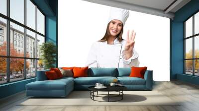 Young chef caucasian woman over isolated background happy and counting three with fingers Wall mural