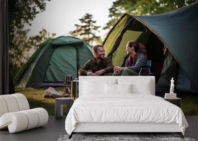 Young couple at outdoors inside a camping tent Wall mural