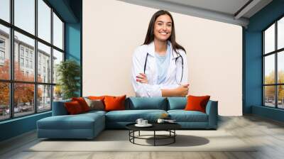 Young doctor woman over isolated background laughing Wall mural