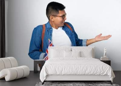 Young Ecuadorian woman holding an United Kingdom flag isolated on white background with surprise expression while looking side Wall mural