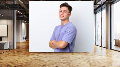 Young handsome Brazilian man isolated on white background with arms crossed and looking forward Wall mural