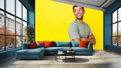 Young handsome Brazilian man isolated on yellow background happy and smiling Wall mural