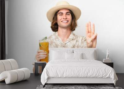 Young handsome man holding a cocktail isolated on white background happy and counting three with fingers Wall mural