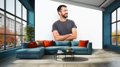 Young handsome man over isolated white background happy and smiling Wall mural