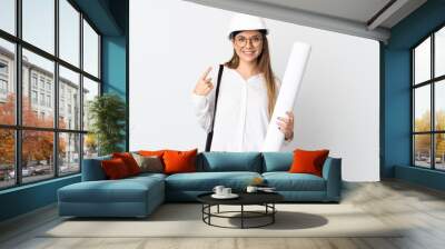 Young Lithuanian architect woman with helmet and holding blueprints isolated on white background giving a thumbs up gesture Wall mural