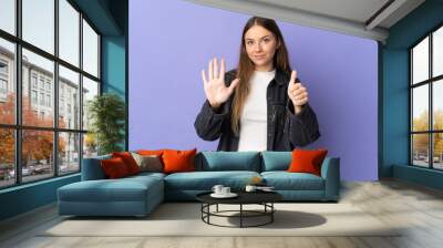 Young Lithuanian woman isolated on purple background counting six with fingers Wall mural