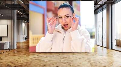 Young moroccan girl  at outdoors With glasses and surprised expression Wall mural