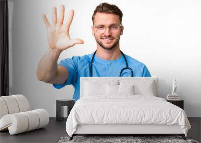 Young nurse man over isolated chroma key background counting five with fingers Wall mural