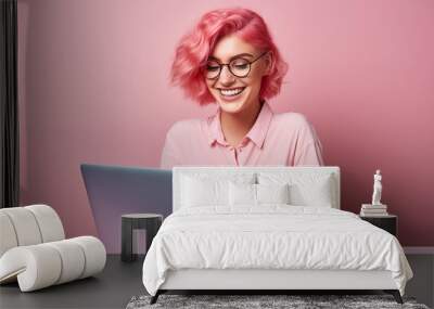 Young pink haired woman over isolated colorful background working with a laptop Wall mural