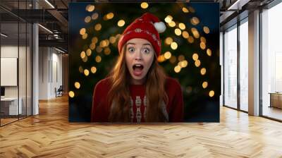 Young pretty redhead woman with christmas hat Wall mural