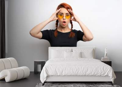 Young redhead woman over white wall with surprise expression Wall mural