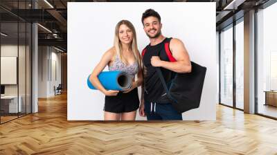 Young sport couple isolated on white background Wall mural