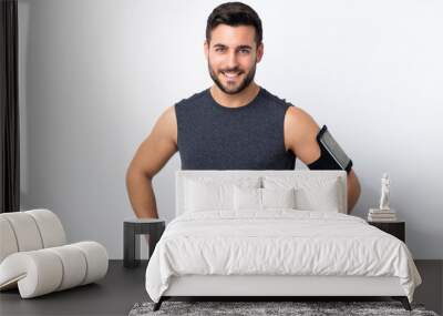 Young sport handsome man with beard over isolated white background posing with arms at hip and smiling Wall mural